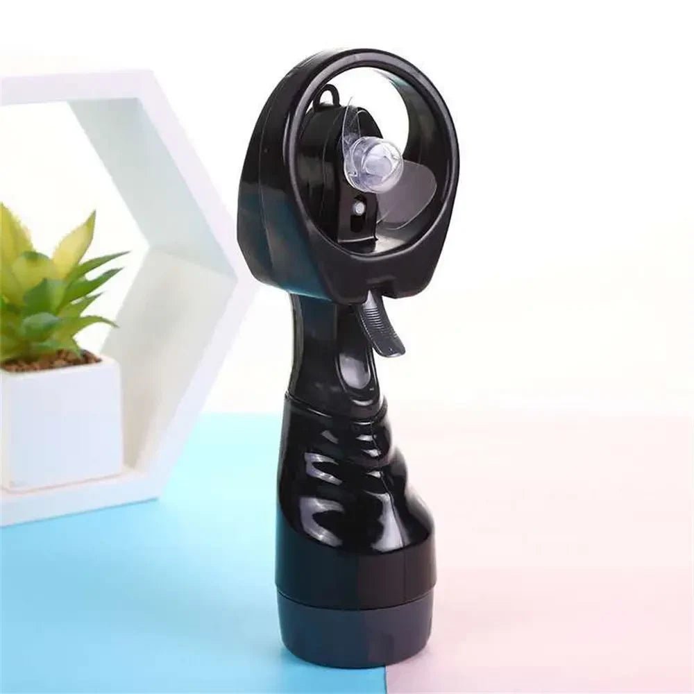 Portable handheld misting fan with rechargeable battery, perfect for travel and outdoor use, featuring a sleek design and cooling spray functionality. 0